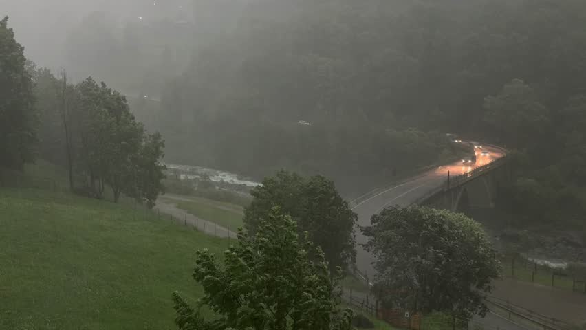 heavy summer storm slows traffic on a bridge