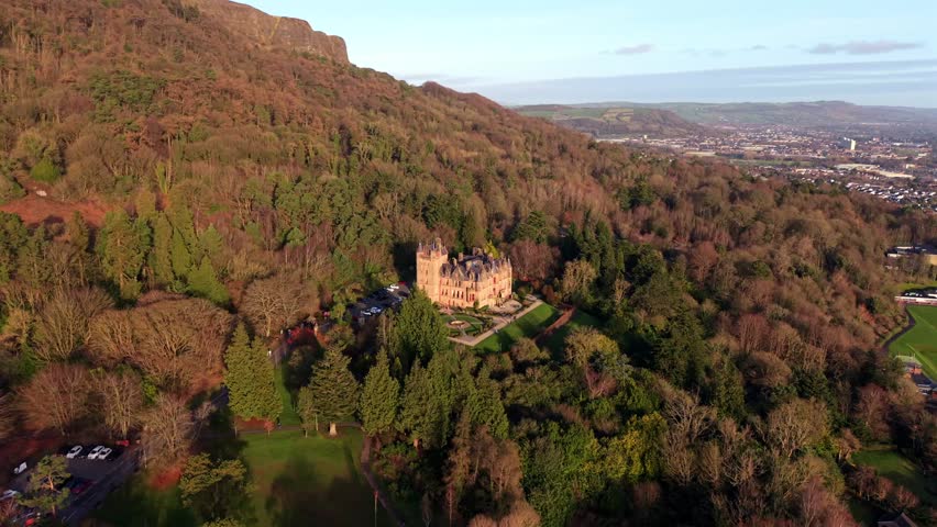 Wide anti-clockwise 4K 60FPS aerial video of Belfast Castle and Cave Hill in North Belfast, Northern Ireland on a crisp autumn day. Produced with Rec709 color.