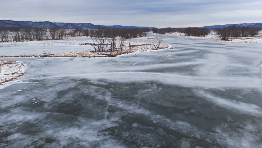 Frozen lazy river and many island on a winter wonderland scenic landscape scene in Driftless Region in Wisconsin Minnesota Fly over