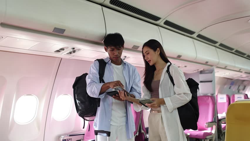 A happy married couple smiles while traveling, carrying their passports and baggage as they embark on a romantic summer vacation journey.