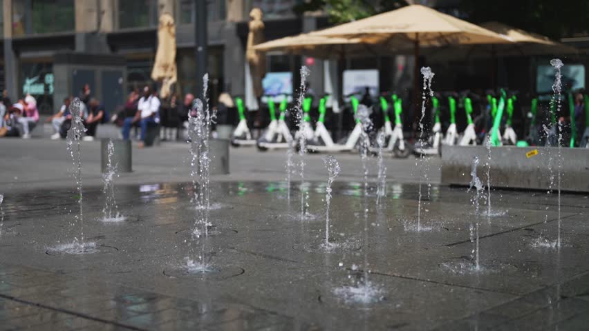 Modern water fountains on a city square.