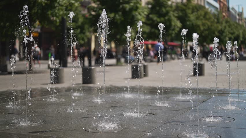Modern water fountains on a city square.