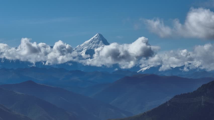 Aerial footage landscape of foggy snow capped mountains in sichuan, China