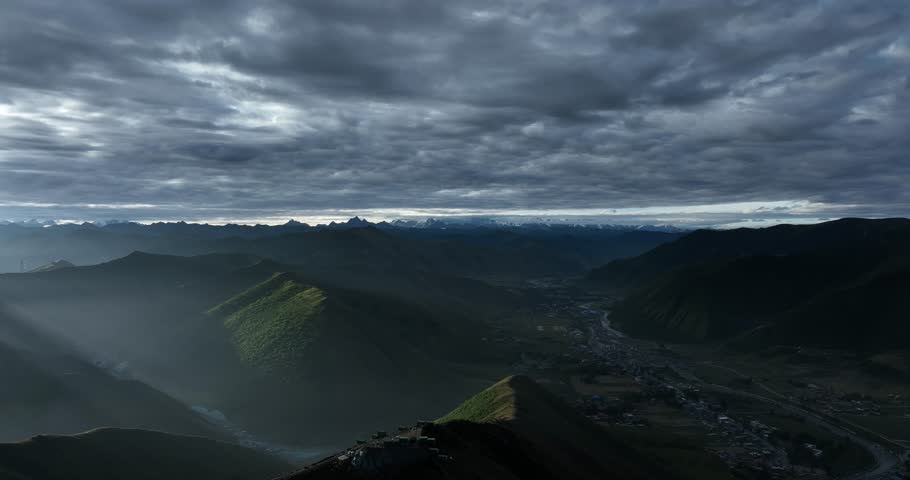 Aerial footage landscape of foggy snow capped mountains in sichuan, China