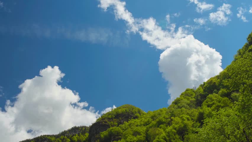 White Clouds Floating Over Green Hills