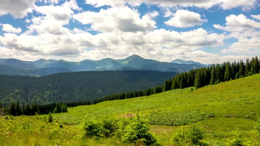 Green Hills and Mountain Landscape Under Blue Sky