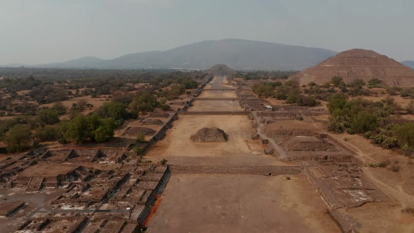 Aerial drone view of Teotihuacan in Mexico, showing the Avenue of the Dead with Sun and Moon Pyramids, historic citadel complex in the valley.