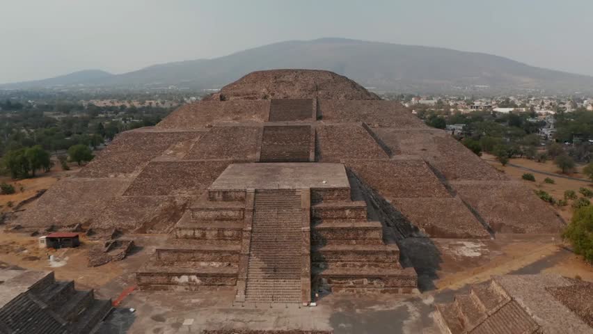 Drone view of the Pyramid of the Moon at Teotihuacan, Mexico, showcasing massive Mesoamerican temple, UNESCO site, and historic cultural landmark.