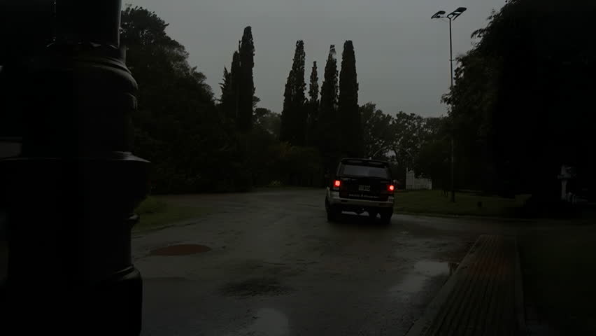 Cars Driving Away on a Rainy Day
