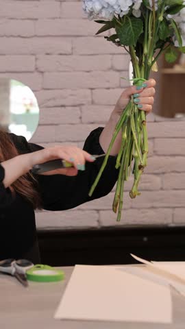 Florist cutting hydrangea and peony stems