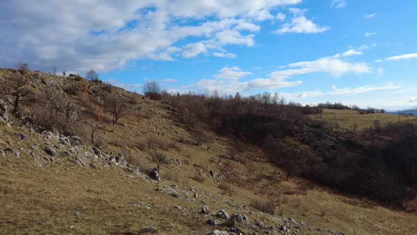 Sky and Clouds Above Rocky Hill
Open sky with clouds drifting above a rocky hill covered with natural vegetation. The scene highlights raw landscape textures, stones, plants and atmospheric clouds, creating a calm and natural outdoor environment.