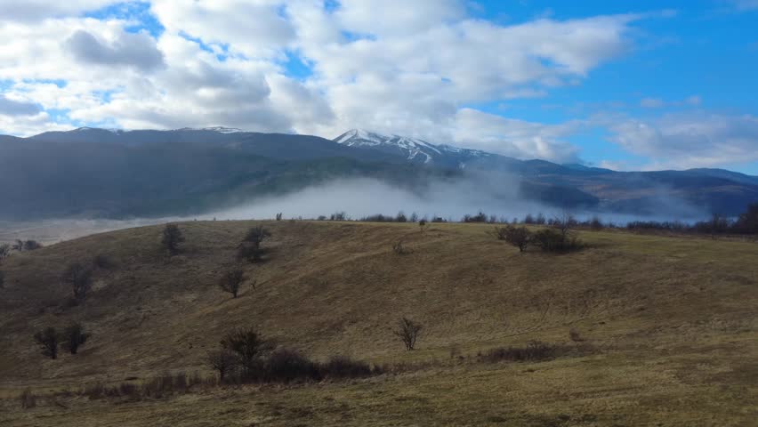 Mountain Landscape with Moving Mist and Fog
Mountain landscape with patches of mist slowly moving across the peaks and valleys. The drifting fog creates a calm, atmospheric and cinematic scene, highlighting the beauty of untouched nature, tranquility and changing weather conditions.