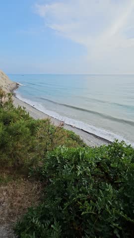 Mediterranean coastline on summer day and sea	with waves