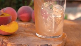 Fresh peach juice pouring into a clear glass creating a beautiful wave and splash. Healthy refreshing fruit drink flowing in slow motion close up - Powered by Shutterstock - Get 15% off with code: PIKWIZARD15