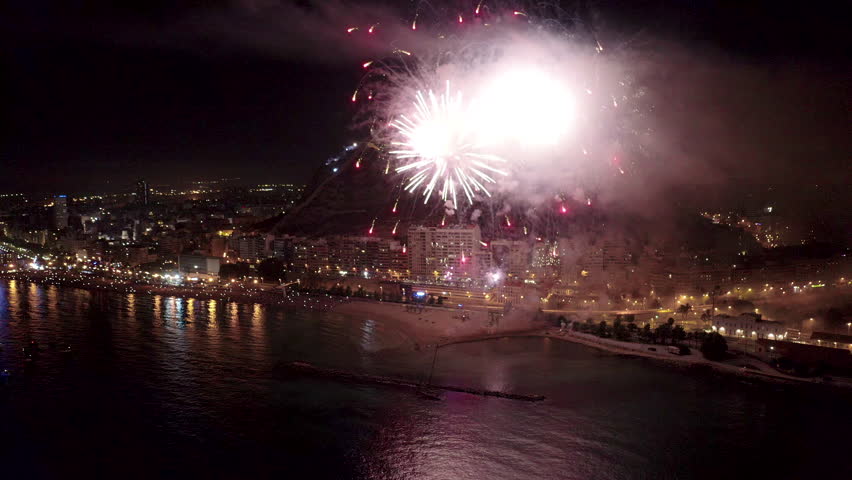 Nocturne aerial view of the fireworks launched in the beach of El Postiguet, in the Mediterranean city of Alicante, Spain.