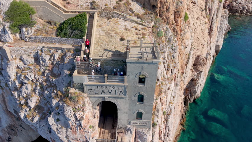  castle nestled on vertical cliffs above serene mediterranean coves near italy. Porto Flavia. 