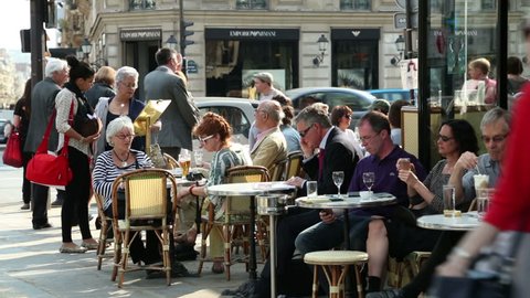 PARIS - APRIL 26: Unidentified people sit at Paris cafe, Deux Magots on April 26, 2013 in Paris. Intellectuals and writers like Jean-Paul Sartre and Ernest Hemmingway were patrons of this cafe.