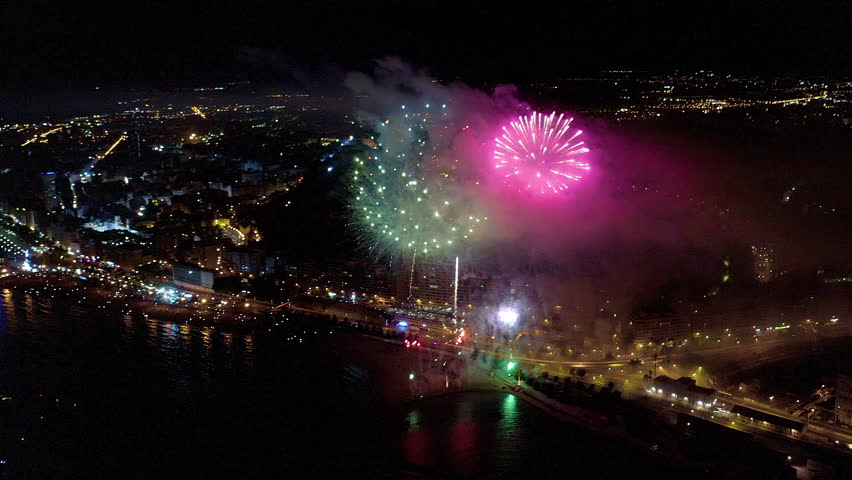 Nocturne aerial view of the fireworks launched in the beach of El Postiguet, in the Mediterranean city of Alicante, Spain.