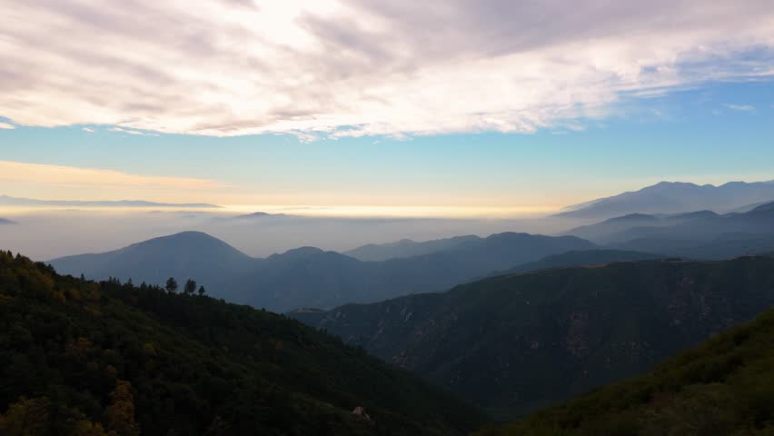 Aerial View of Layered Mountain Ridges at Sunrise