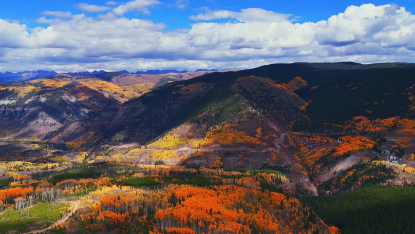 Gilman ghost town Mount of the Holy Cross Wilderness Sawatch Gore Range Minturn Red Cliff Vail aerial drone Fall Autumn cloudy morning Rocky Mountains Colorado colorful Aspen trees circle left motion