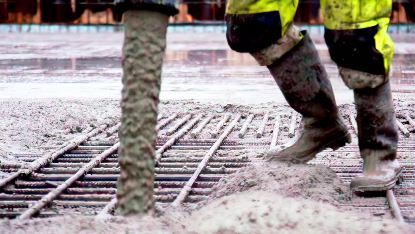 Pouring ready-mixed concrete onto a construction building site foundation structural element