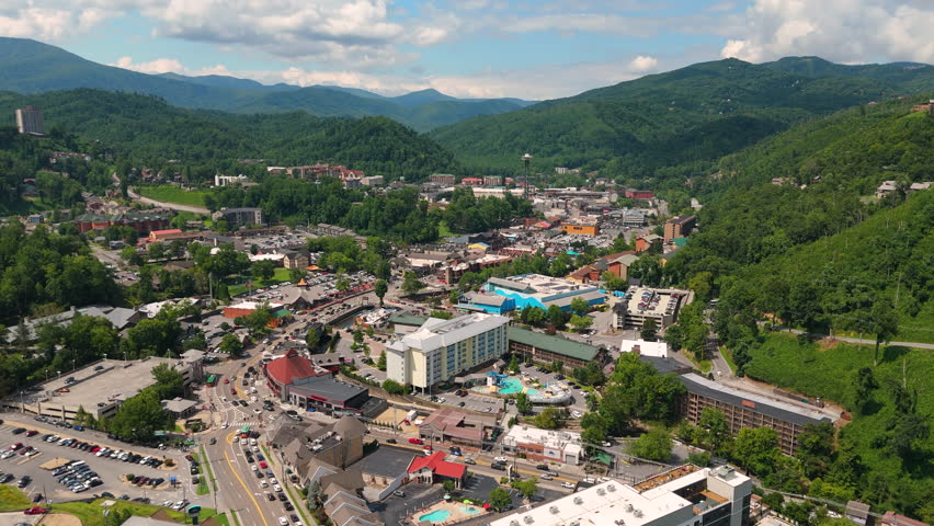 Aerial view of Gatlinburg, Tennessee with downtown hotels, restaurants and tourist shops along the Parkway street surrounded by Appalachian Mountains.