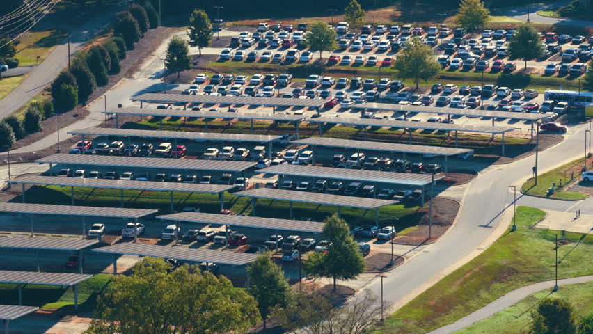 Eco-friendly car parking area covered with photovoltaic panels. Sustainable infrastructure providing both shade for vehicles and renewable energy production.