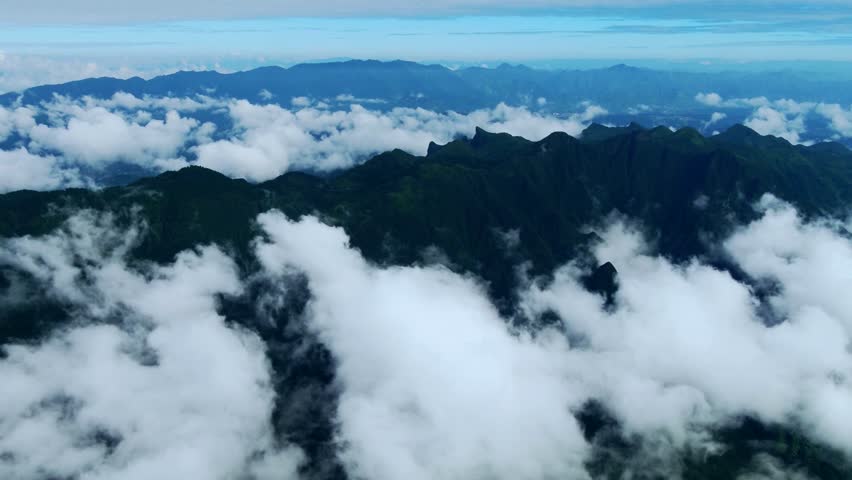 Breathtaking 4K UHD aerial time-lapse footage of Shennongjia Dajiuhu’s iconic alpine wetland scenery—nine connected lakes nestled among mountains, shrouded in ethereal morning mist and glowing under golden hour sunlight. Capturing cloud seas drifting over lush meadows, crystal-clear lakes reflecting sky and ridges, and the serene harmony of this peat bog ecosystem, the video embodies the "wetland in clouds" charm. Perfect for Shutterstock users—ideal for travel promotions, eco-tourism campaigns, nature documentaries and commercial projects seeking striking Chinese alpine wetland content.