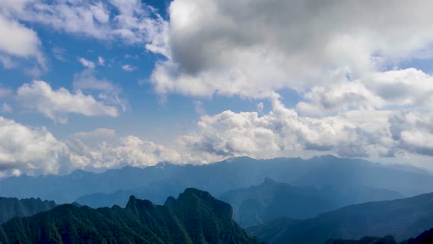 Breathtaking 4K UHD aerial time-lapse footage of Shennongjia Dajiuhu’s iconic alpine wetland scenery—nine connected lakes nestled among mountains, shrouded in ethereal morning mist and glowing under golden hour sunlight. Capturing cloud seas drifting over lush meadows, crystal-clear lakes reflecting sky and ridges, and the serene harmony of this peat bog ecosystem, the video embodies the "wetland in clouds" charm. Perfect for Shutterstock users—ideal for travel promotions, eco-tourism campaigns, nature documentaries and commercial projects seeking striking Chinese alpine wetland content.