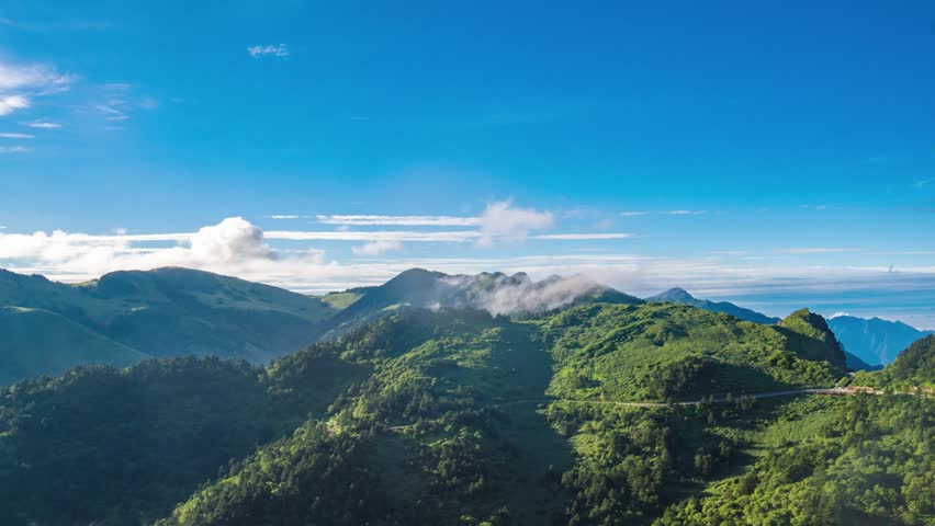 Breathtaking 4K UHD aerial time-lapse footage of Shennongjia Dajiuhu’s iconic alpine wetland scenery—nine connected lakes nestled among mountains, shrouded in ethereal morning mist and glowing under golden hour sunlight. Capturing cloud seas drifting over lush meadows, crystal-clear lakes reflecting sky and ridges, and the serene harmony of this peat bog ecosystem, the video embodies the "wetland in clouds" charm. Perfect for Shutterstock users—ideal for travel promotions, eco-tourism campaigns, nature documentaries and commercial projects seeking striking Chinese alpine wetland content.