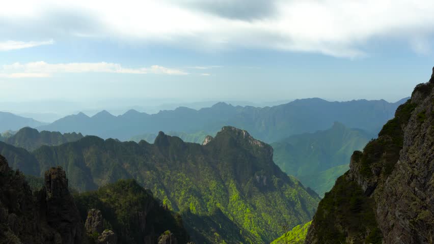 Breathtaking 4K UHD aerial time-lapse footage of Shennongjia Dajiuhu’s iconic alpine wetland scenery—nine connected lakes nestled among mountains, shrouded in ethereal morning mist and glowing under golden hour sunlight. Capturing cloud seas drifting over lush meadows, crystal-clear lakes reflecting sky and ridges, and the serene harmony of this peat bog ecosystem, the video embodies the "wetland in clouds" charm. Perfect for Shutterstock users—ideal for travel promotions, eco-tourism campaigns, nature documentaries and commercial projects seeking striking Chinese alpine wetland content.
