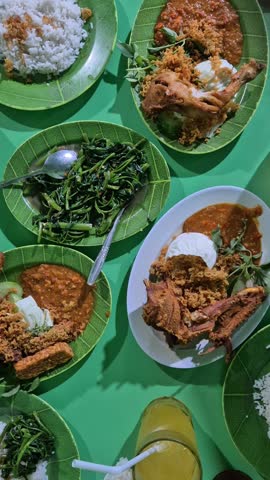 indonesian food, fried chicken, kangkung, rice at table
