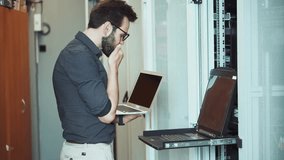 IT Specialist Or System Administrator Working In Data Center Server Room. Technician Using Laptop Typing On Terminal Keyboard While Monitoring Network Hardware. Cyber Security Expert Checking Server - Powered by Shutterstock - Get 15% off with code: PIKWIZARD15