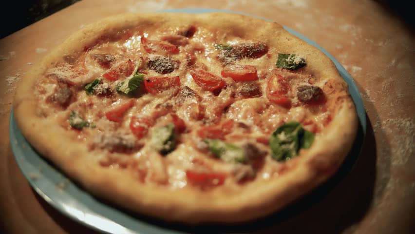 Freshly Baked Italian Pizza With Melting Cheese Cherry Tomatoes And Green Basil Leaves. Hot Homemade Neapolitan Dough Dish. Mediterranean Cuisine Appetizing Crispy Crust Dough. Pizza Fast Food Baked