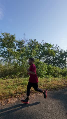 Slow motion of Man Running on Path Outdoors on Sunny Day