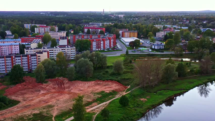 Aerial Construction Scene with Excavated Plot for Residential Bulding and City Background in Valmiera, Latvia