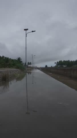 Person Riding Bicycle on Flooded Street