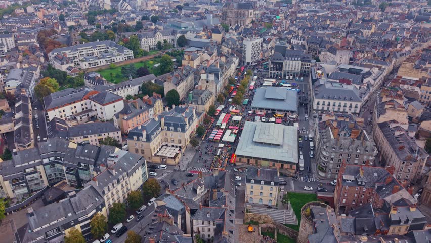 Place des Lices public square during market day with basilique Saint-Aubin en Notre-Dame-de-Bonne-Nouvelle in background from above, Rennes, Ille-et-Vilaine, France