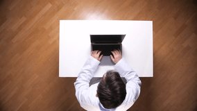 Medical professional doctor or scientist in a lab coat typing on a laptop computer at a white desk, performing research and data analysis in healthcare technology - Powered by Shutterstock - Get 15% off with code: PIKWIZARD15