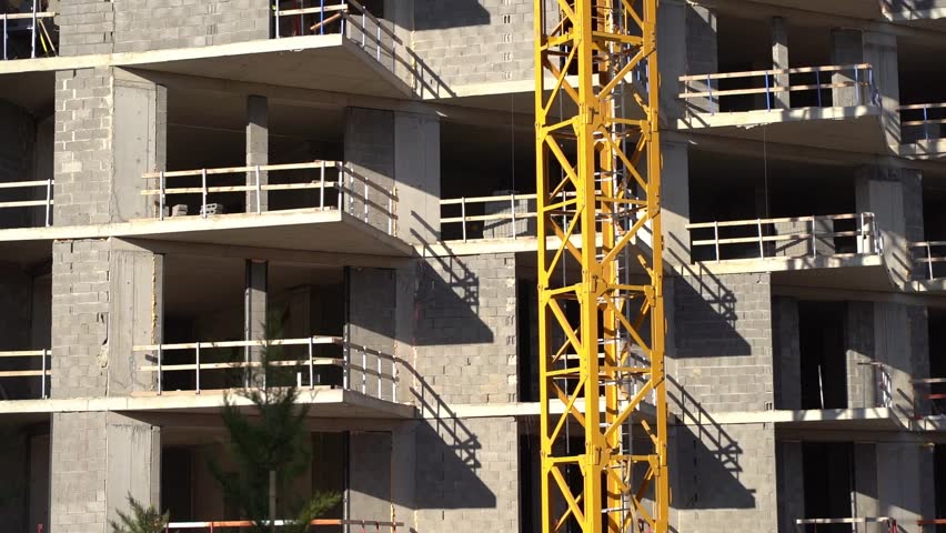 Construction of a building. Construction site with crane. Business, development, industry.