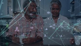 Animation of network of connections over happy senior couple working on laptop at home. home office and online working concept digitally generated video. - Powered by Shutterstock - Get 15% off with code: PIKWIZARD15