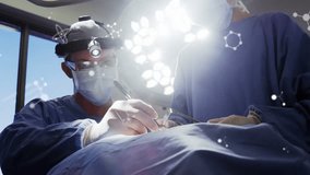 Animation of molecular structures over two surgeons operating on patient in operating theatre. Medical services, data and communication network concept digitally generated video. - Powered by Shutterstock - Get 15% off with code: PIKWIZARD15