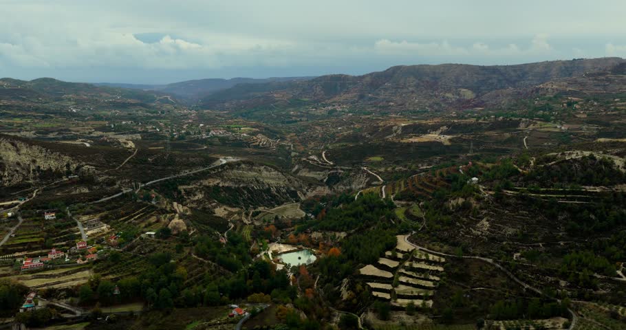 Drone lateral flyover across Cyprus countryside landscape with hills and valleys