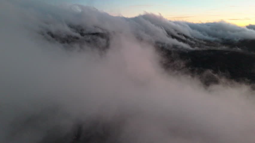 Misty mountains at sunrise, serene and atmospheric aerial view