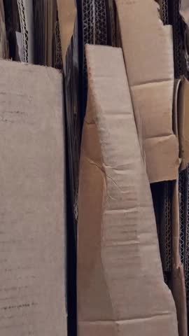 Compacted cardboard recycling bale showing stacked brown paper materials