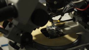 Macro close-up of semiconductor microchip under microscope on probe station, precision micromanipulators positioning test probes for electronics testing in a laboratory setup - Powered by Shutterstock - Get 15% off with code: PIKWIZARD15