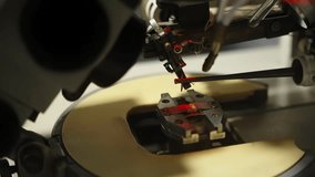 Precision station examining a semiconductor microchip under microscope illumination, with robotic micromanipulators aligning fine probes onto contact pads for electronic testing. - Powered by Shutterstock - Get 15% off with code: PIKWIZARD15
