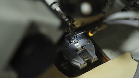 Close-up of wire bonding on a microchip under a microscope, with bonding tool aligning to die pads and leads during semiconductor assembly for microelectronics manufacturing - Powered by Shutterstock - Get 15% off with code: PIKWIZARD15