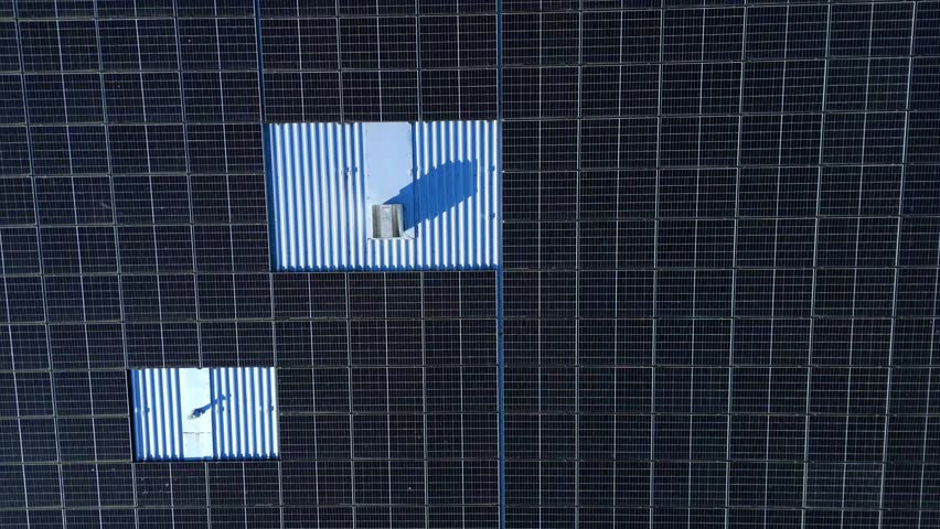 Aerial view of solar panels atop Nene Business Centre, displaying a pattern against the metal roof, Irthlingborough, United Kingdom.