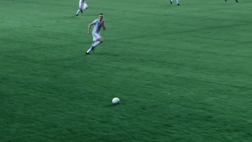 European Football Championship: African Blue Team Soccer Player Attacks and Scores a Goal, Winning Major League Cup. Sport Channel Broadcast Television Playback. Close Up Tracking Shot